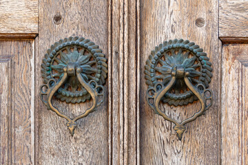 old metal knockers on the door of a historic building