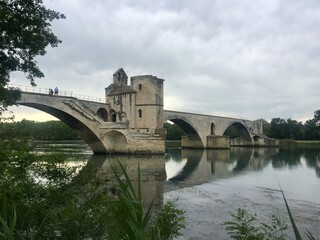 Fototapeta premium Pont d'Avignon bridge over Rhone in Avignon,Provence. View of Pont d’Avignon (famous medieval bridge) from Boulevard de la Ligne. Historic remains of 12th century bridge over Rhone river in Provence 
