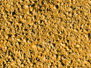 Old yellow concrete wall close-up.