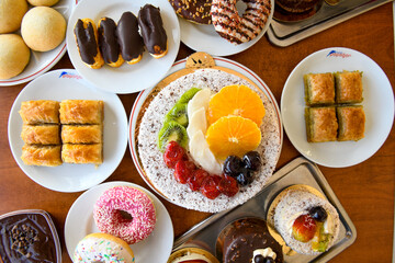 Table scene of assorted take out or delivery foods. Traditional Turkish cuisine. Various Turkish desert and cake. Top down view on a table.