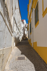 Street in the old town of the fortified city of Elvas (World Heritage Site by UNESCO) with its traditional white facades. Alentejo region, Portugal.