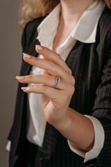 Golden Ring on a female hand, diamonds Diamond ring in hands of young lady. Close-up photo shoot