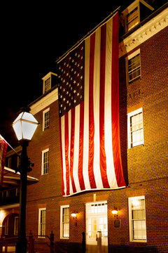 United States of America Flag at night hanging on City Hall in Alexandria, Virginia.