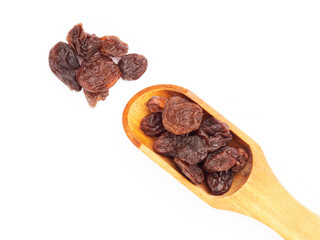 Raisin in scoop and bunch isolated on white. Macro. Healthy food concept