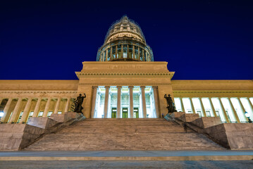 Old Havana, Cuba. The classic architecture, white steps and dome of the Capitolio building on the streets of Habana Vieja at night.