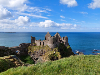 Fototapeta na wymiar Dunluce castle, in Northern Ireland, United Kingdom. It's an abandoned, now-ruined medieval castle, the seat of Clan McDonnell, built on the edge of a basalt outcropping in County Antrim 