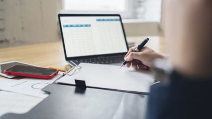 Finance accountant workplace man uses laptop report in company electronic documents.