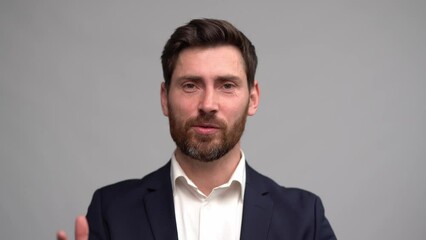 Man in business suit talking to camera actively gesticulating, coach keeping online lection