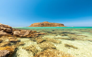 Paradise beach of Balos in Crete, Greek holiday island landscape, Crystal clear water, charming rocks on the shore