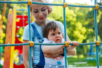 beautiful girl with children on a children's playground