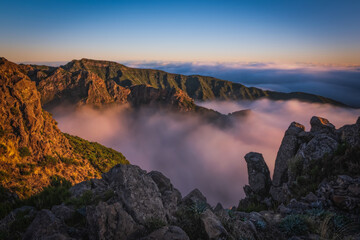 Mountain trail Pico do Arieiro, Madeira Island, Portugal Scenic view of steep and beautiful mountains and clouds during sunrise. October 2021