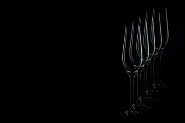 Silhouette of champagne glasses, with reflection diagonally backwards, on black background. Copy space for your design. Web banner. 