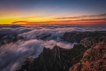 Obraz premium Mountain trail Pico do Arieiro, Madeira Island, Portugal Scenic view of steep and beautiful mountains and clouds during sunrise. October 2021. Long exposure picture