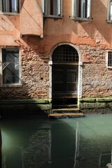 Fototapeta na wymiar Italy, Veneto, Venice: Old door on the Canal.