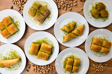 Top view of table scene with assorted take out or delivery foods. Meat and chicken doner kebab sandwich, wrap and on the plate with vegetables and sauce, including fries and pickles.