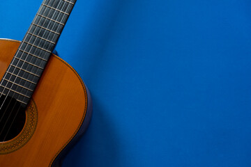 Obraz premium old classic guitar on blue table background, music concept