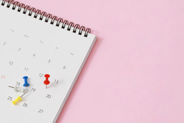 close up of calendar on the table pink background. empty copy space for text.