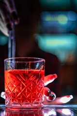 bartender hand making negroni cocktail. Negroni classic cocktail and gin short drink with sweet vermouth, red bitter liqueur