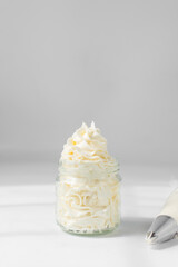 Piped american buttercream in a glass, buttercream swirl on glass, textured buttercream in glass jar