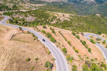 Fototapeta na wymiar Meandering serpentine road in the mountain. Aerial view. Copter, drone view