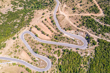 Meandering serpentine road in the mountain. Aerial view. Copter, drone view
