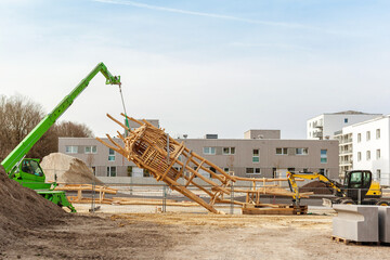 Playground Under Construction. Building Wooden Playground on Urban Place in New Residential Area. Crane Installs Wooden Structure on New Playground.