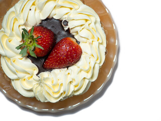 Cake with butter cream and strawberries. Cake on a white background. Treat for tea. Sweets.