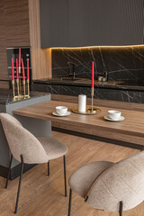 kitchen area in a chic expensive interior of a luxury home with a dark black and brown modern design with wood trim and led light