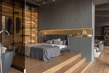 Fotobehang Hotel chique bedroom and freestanding bath behind a glass partition in a chic expensive interior of a luxury home with a dark modern design with wood trim and led light  © 4595886