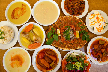 Traditional Turkish cuisine. Pizza, pita, pidesi, sucuk, hummus, kebab. Many dishes on the table. Serving dishes in restaurant. Background image. Top view, flat lay