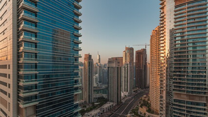 Panoramic view of the Dubai Marina and JBR area and the famous Ferris Wheel aerial morning timelapse