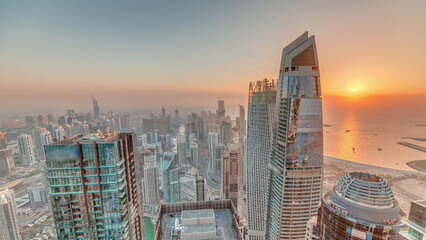 Plakat Sunset view of Dubai Marina showing an artificial canal surrounded by skyscrapers along shoreline timelapse. DUBAI, UAE