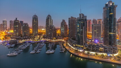 Obraz premium Luxury yacht bay in the city aerial night to day timelapse in Dubai marina