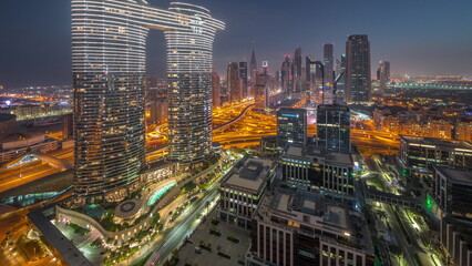 Naklejka na ściany i meble Futuristic Dubai Downtown and finansial district skyline aerial night to day timelapse.