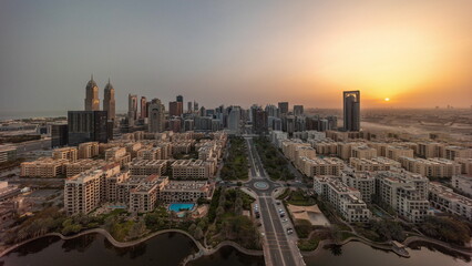 Naklejka na ściany i meble Panorama of skyscrapers in Barsha Heights district and low rise buildings in Greens district aerial all day timelapse.