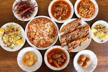 Traditional Turkish cuisine. Pizza, pita, pidesi, sucuk, hummus, kebab. Many dishes on the table. Serving dishes in restaurant. Background image. Top view, flat lay
