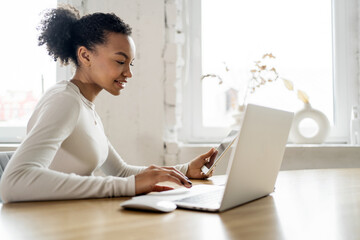 Video communication female freelancer workplace uses laptop computer company report in office coworking space