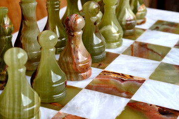Onyx chess pieces on a chessboard. Black  team is ready for action