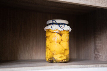 Jar with marinated yellow scallop squash, homemade pickled pattypan squash