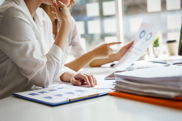 Two Asian female employees and excessive work in the office, close up shot.