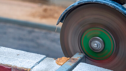 Close-up view of a worker working with angle grinder. Electric wheel grinding on steel structure. Sparks.