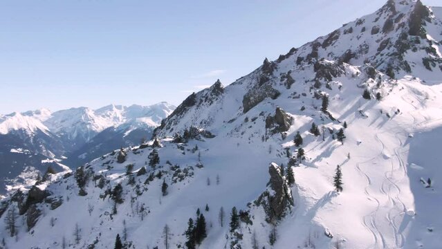 austrian winter mountain landscape for skiing filmed by a drone at a sunny day
