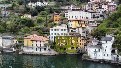 Fototapeta na wymiar Beautiful view from the lake to the shore with villas. Old town with a bridge