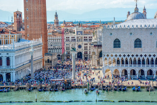 San Marco square with tourists in Venice, Italy. It's the principal public square of Venice, Italy, where it is generally known just as the Piazza.
