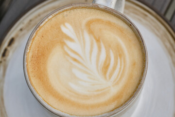 Cup of latte coffee or cappuccino in a cup. Shallow depth of field