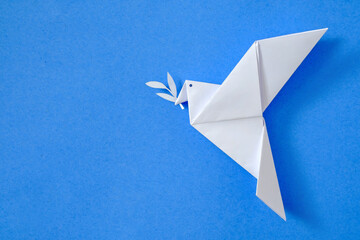 Dove of peace on blue sky background concept from origami toy leisure and hobby and poster with...