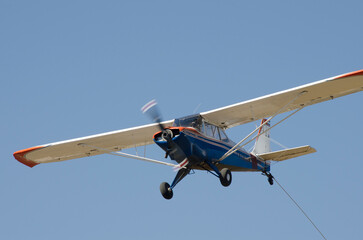 light aircraft flying, propeller plane flying towing ultralight glider