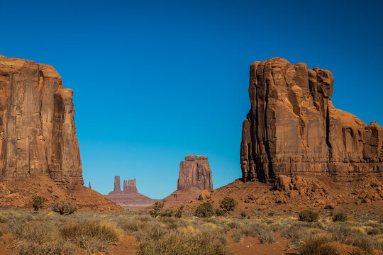 Classic southwest desert landscape under a blue sky and bright sun in Monument Valley in Arizona and Utah. © Jason Yoder