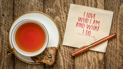 I love who I am and what I do - positive affirmation words on a napkin with a cup of tea, self...