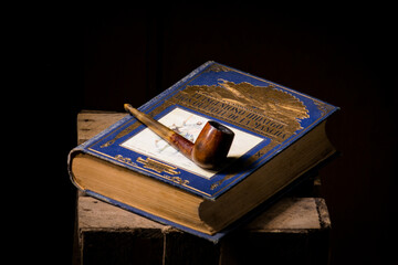 old book (Don Quijote) and smoking pipe